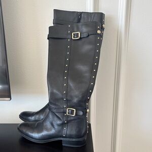 Vince Camuto black boots with gold studs/accents.